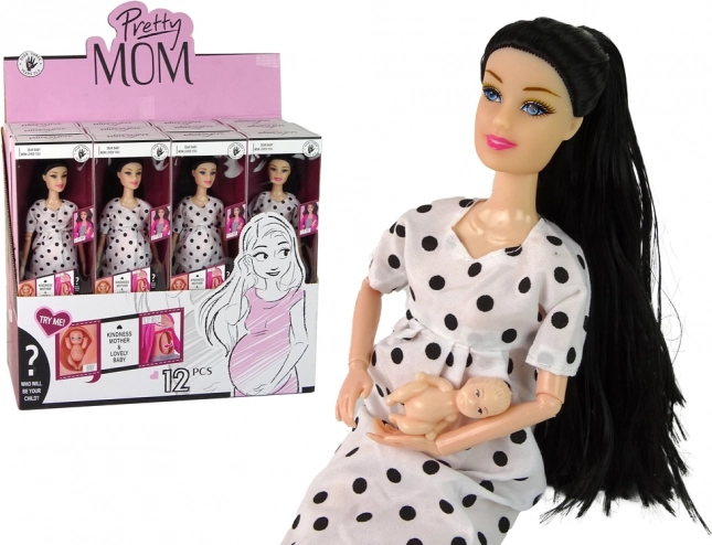 Pregnant doll in white polka dot dress