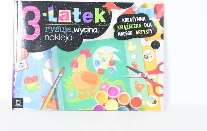 A 3-year-old draws, cuts and glues – creative activity book