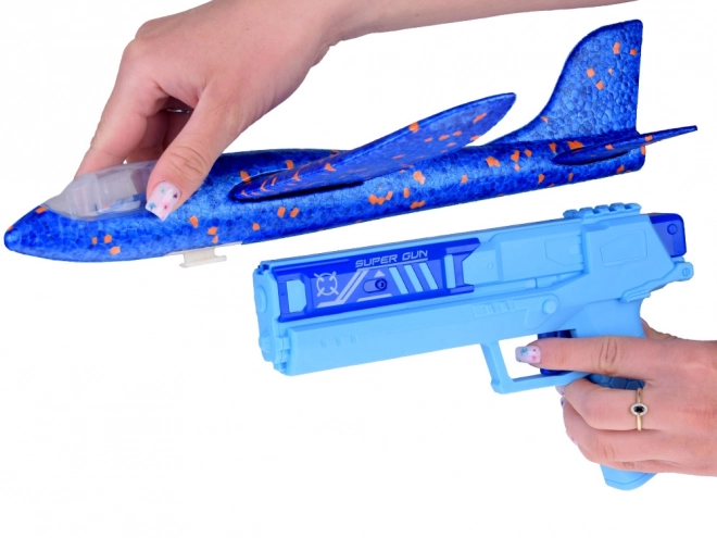 Avion en mousse avec lumière LED lancé depuis un pistolet