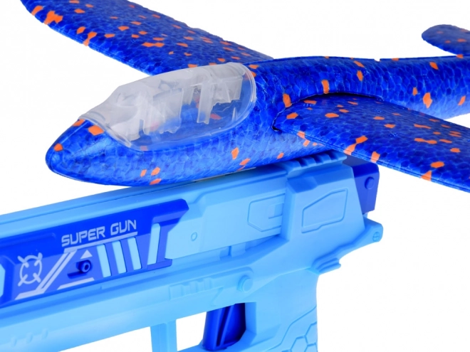 Avion en mousse avec lumière LED lancé depuis un pistolet