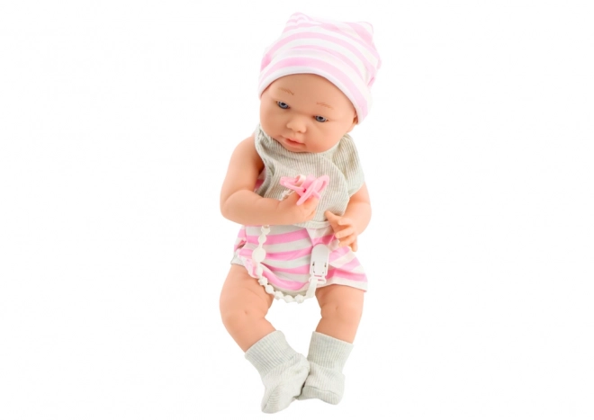 Stoffbaby in Weiß-Rosa Kleidung mit Mütze und Schnuller