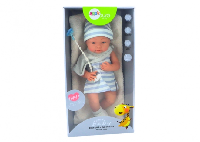 Puppe Baby in Weiß-blauem Outfit mit Mütze und Schnuller