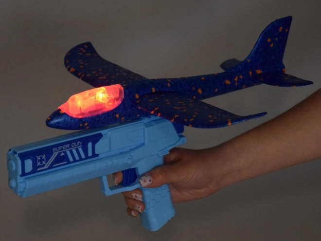 Avion en mousse avec lumière LED lancé depuis un pistolet