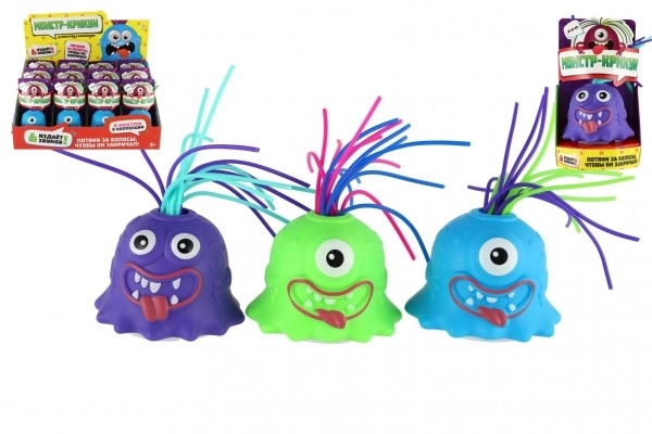 Monstre avec ventouse en plastique 7cm fonctionnant avec des piles avec son, lumière 3 couleurs en boîte de 12 pièces