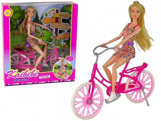 Pop op een roze fiets