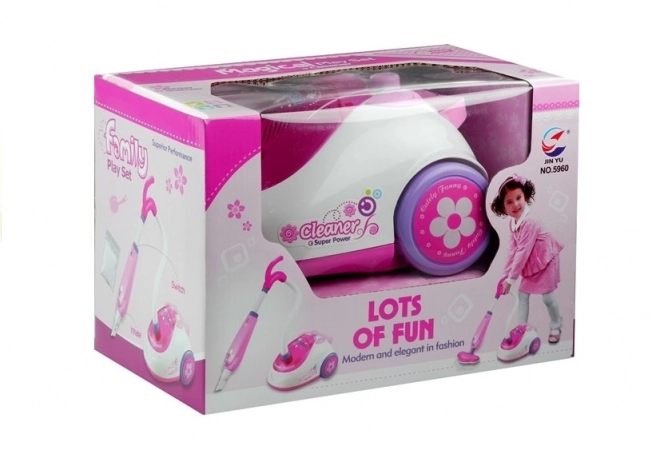 Roze kinderstofzuiger op batterijen met twee opzetstukken
