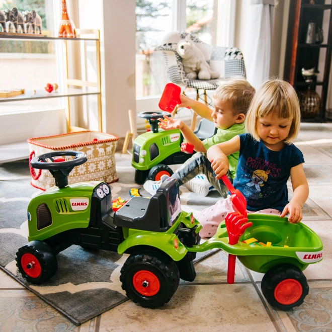 Duwtractor Claas groen met stuur en aanhanger