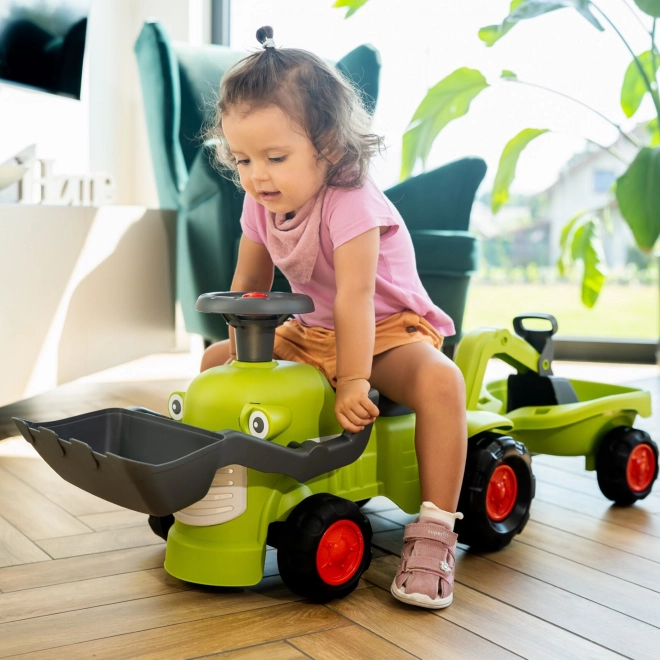 Rijdende tractor Claas met aanhanger, lader en schep