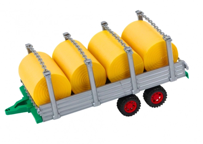Grote tractor met aanhanger en pakken hooi