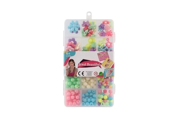 Gekleurde plastic kralen met draad in plastic doos 10x17x2cm