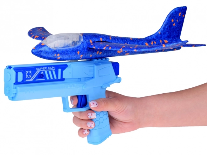 Avion en mousse avec lumière LED lancé depuis un pistolet