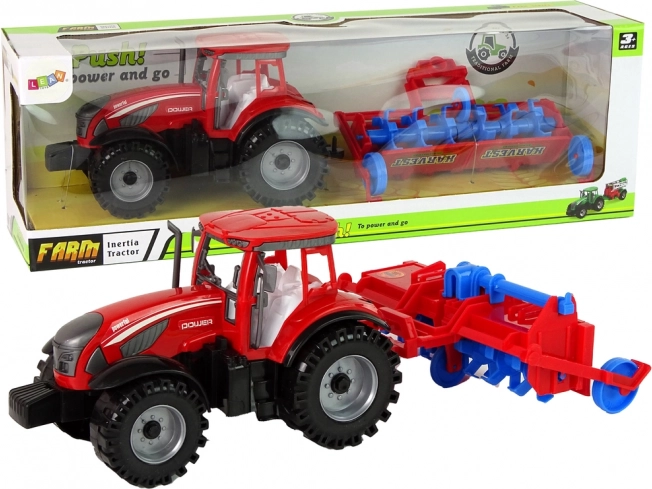 Red tractor with plough with friction drive