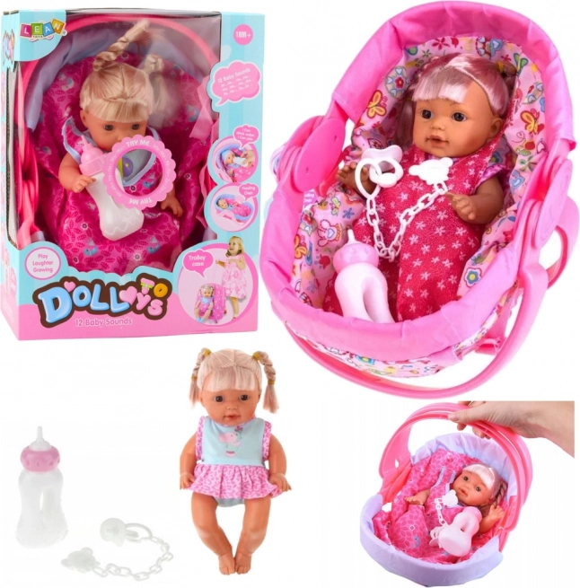 Interactive baby doll in a carrier with sounds and accessories 30 cm