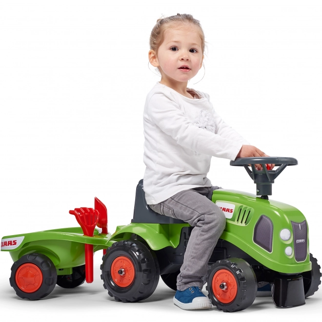 Duwtractor Claas groen met stuur en aanhanger