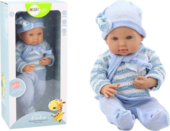 Baby doll in a blue striped sweater with hat and scarf