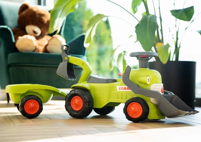 Rijdende tractor Claas met aanhanger, lader en schep