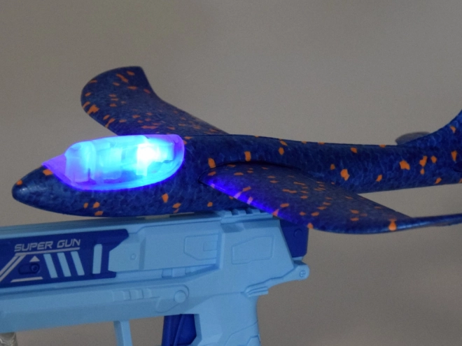Avion en mousse avec lumière LED lancé depuis un pistolet