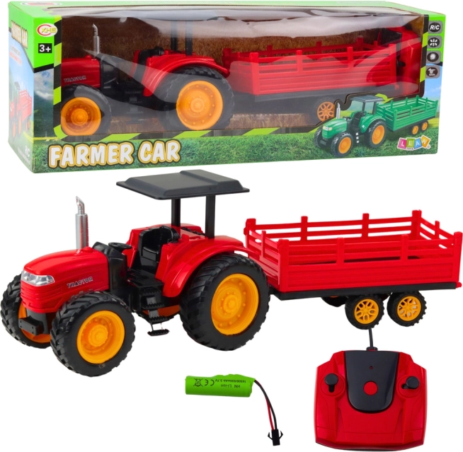 Op afstand bestuurbare boerentractor met aanhanger rood