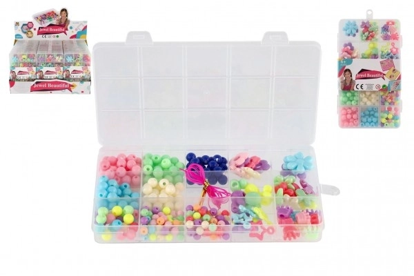 Gekleurde plastic kralen met draad in plastic doos 10x17x2cm