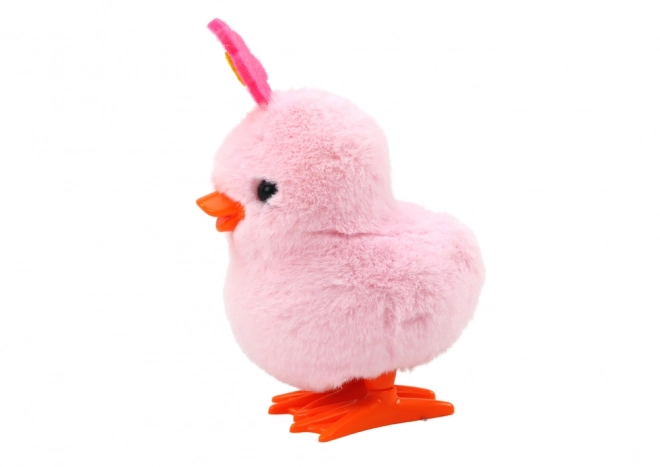 Roze springende kuikentje op een sleutel