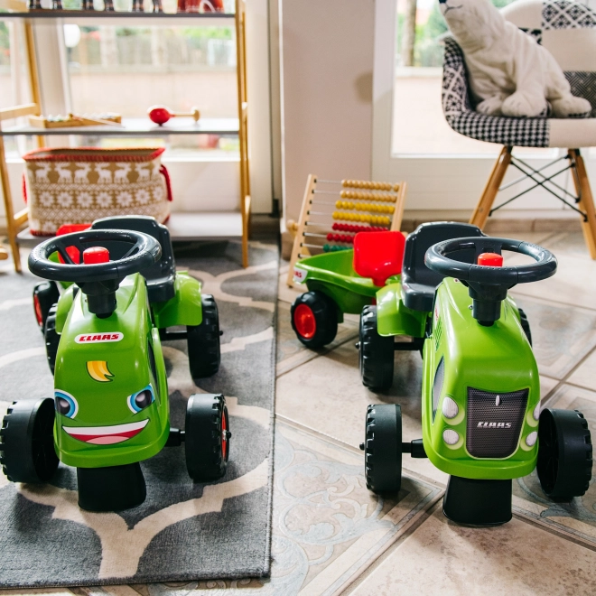 Duwtractor Claas groen met stuur en aanhanger