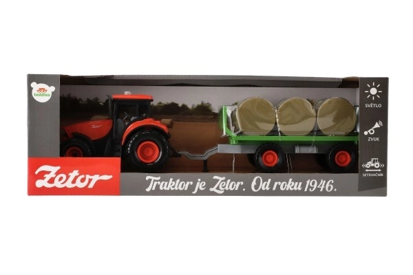 Tractor Zetor met aanhanger en plastic balen 36cm op vliegwiel op batterij met licht en geluid in doos 39x13