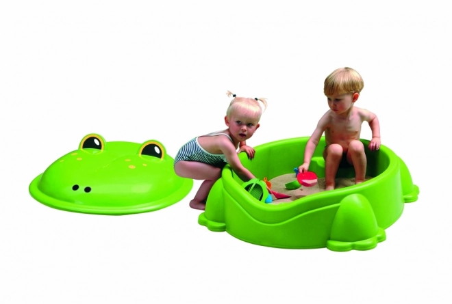 Plastic zandbak in de vorm van een kikker met groen deksel