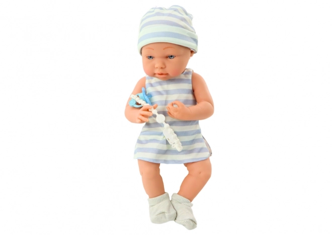 Puppe Baby in Weiß-blauem Outfit mit Mütze und Schnuller