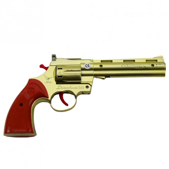Gouden revolver voor capsules met geluidseffect van een schot