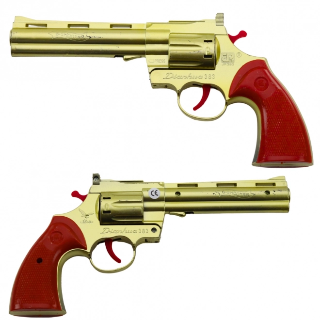 Gouden revolver voor capsules met geluidseffect van een schot