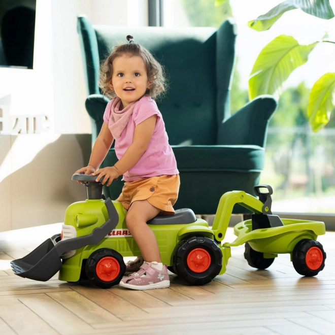 Rijdende tractor Claas met aanhanger, lader en schep