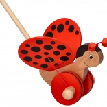 Coccinelle pousse-pousse en bois sur tige