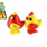 Springend kunststof kuikentje met sleutelaandrijving 7 × 9 cm, 2 kleuren